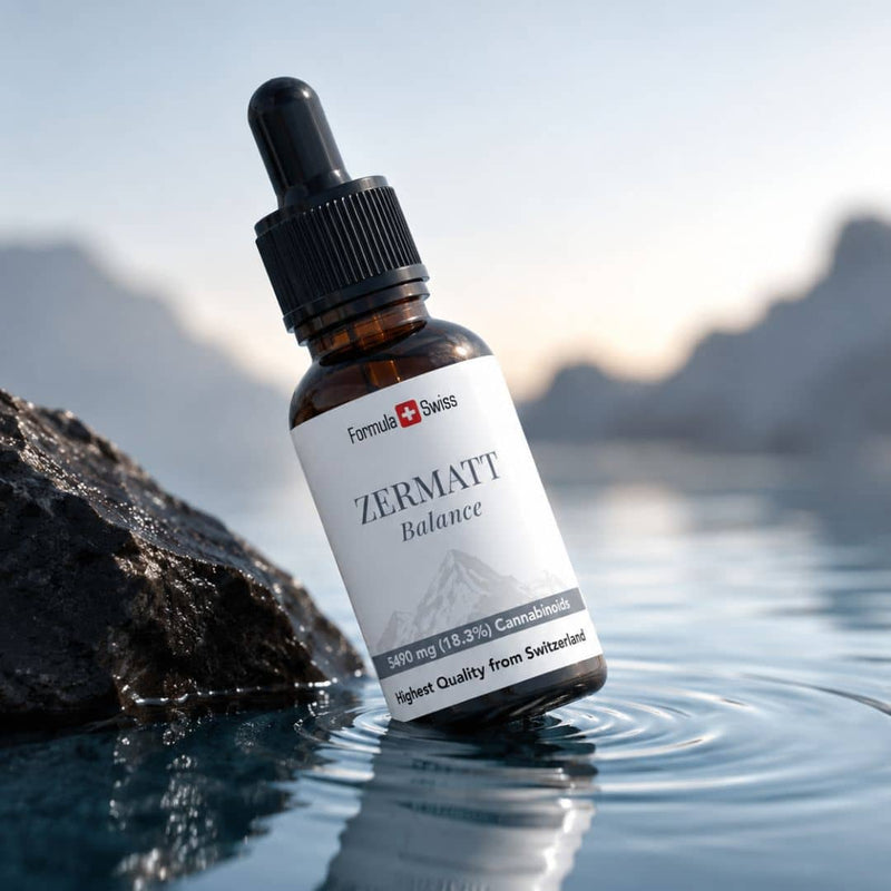 Formula Swiss Zermatt Balance CBD oil bottle displayed beside water and rocks with a Swiss mountain landscape.